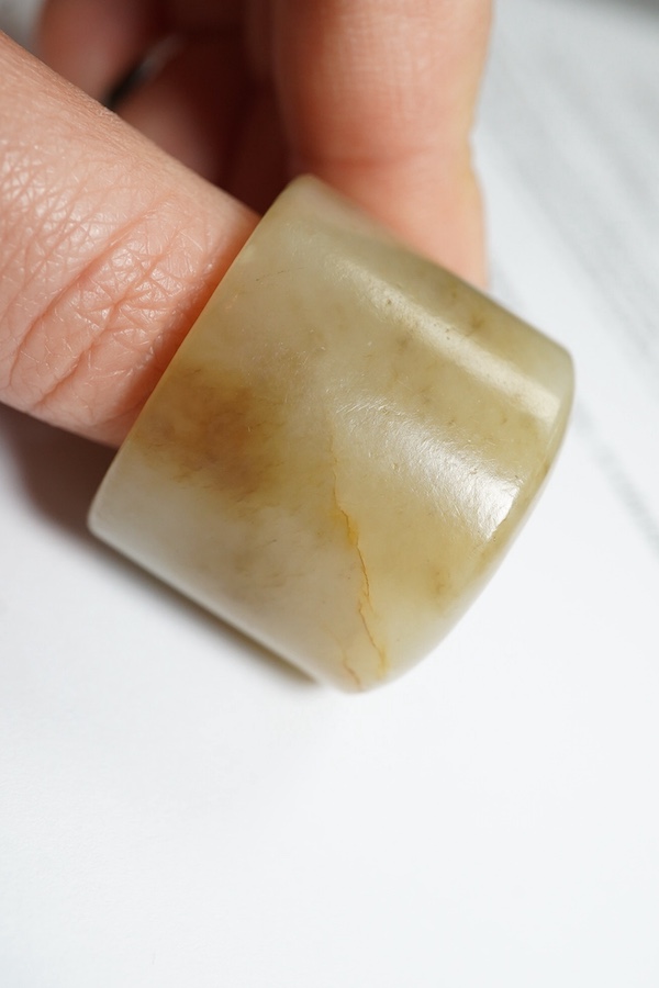 A Chinese pale celadon jade archer's thumb ring, 18th/19th century